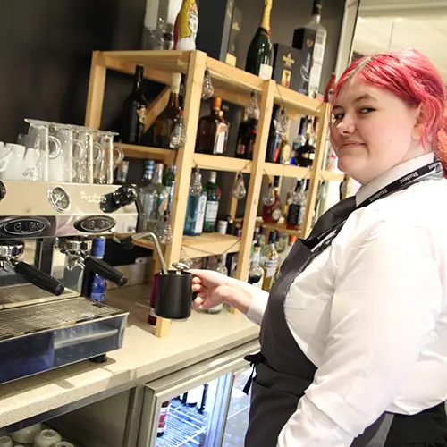 Hospitality student preparing coffee