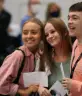 students smiling with their exam results